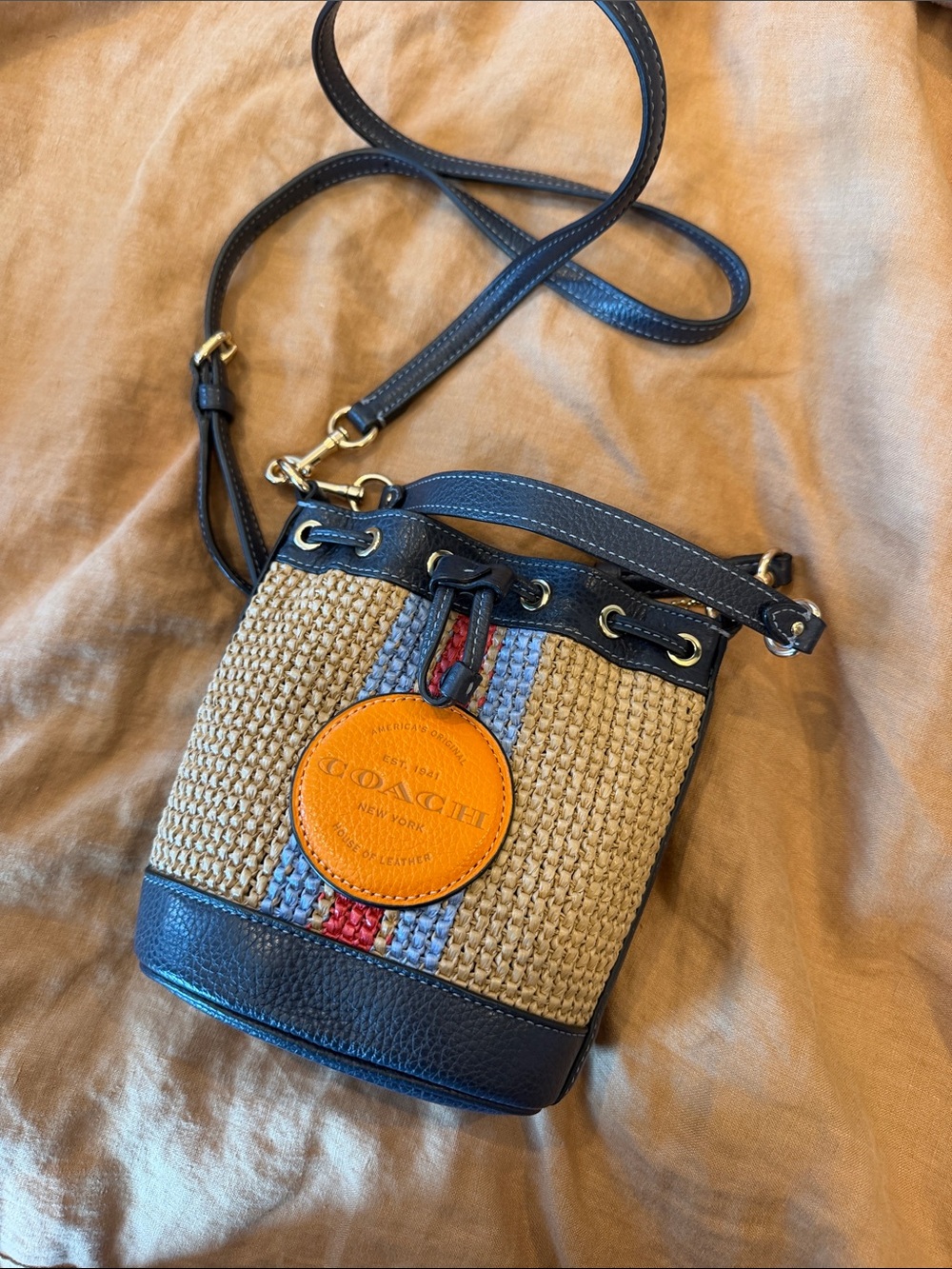 COACH Woven Straw Crossbody with Navy Trim and Orange Logo Patch